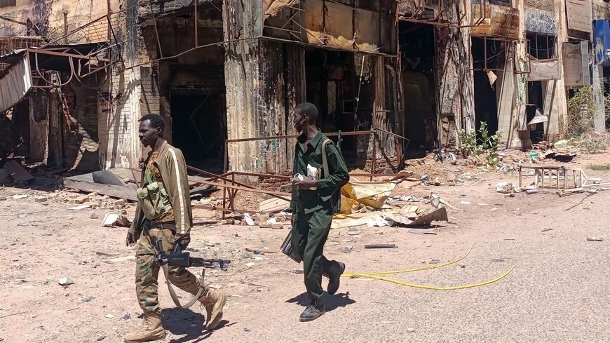 Fighters loyal to the army patrol a market area in Khartoum on March 24, 2025. 