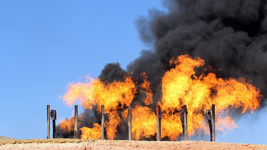 A picture taken on Oct. 17, 2017, shows excess flammable gasses burning from gas flares at the Havana oil field, west of the multiethnic northern Iraqi city of Kirkuk. 