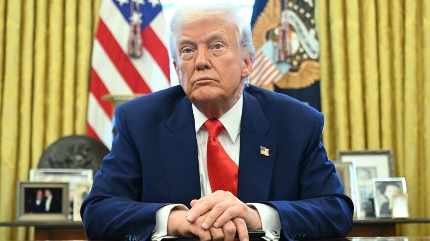 US President Donald Trump looks on after signing an executive order in the Oval Office of the White House on April 9, 2025, in Washington, DC.