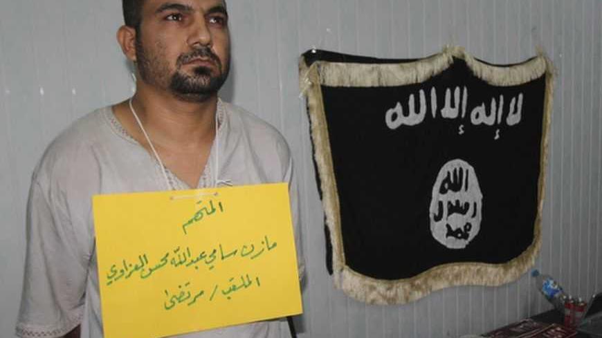 Police present a suspected al-Qaeda militant to the media in Kirkuk, 250 km (155 miles) north of Baghdad, October 7, 2012. Six suspected militants accused of bomb attacks and armed robbery were arrested after raid operations, police in Kirkuk said. REUTERS/Ako Rasheed (IRAQ - Tags : - Tags: CONFLICT CIVIL UNREST CRIME LAW POLITICS)