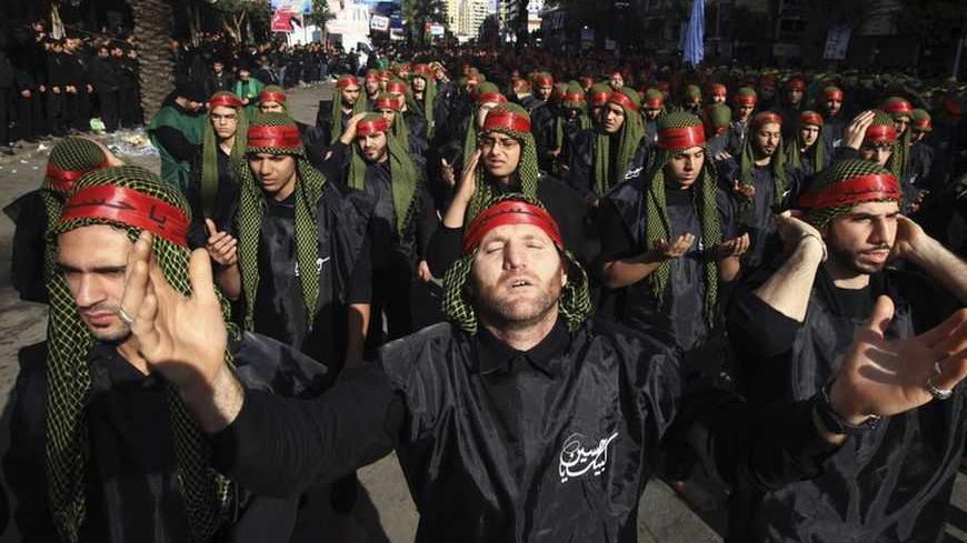Lebanon's Hezbollah supporters gesture as they pray during a ceremony to mark Ashura in Beirut's suburbs, November 25, 2012. Hezbollah leader Sayyed Hassan Nasrallah warned Israel on Sunday that thousands of rockets would rain down on Tel Aviv and other Israeli cities if Israel attacked Lebanon. In a speech marking the Shi'ite Muslim festival of Ashura, Nasrallah said Hezbollah's response to any attack would dwarf the attacks from Gaza during the eight-day conflict between Israel and the Islamist Hamas rule