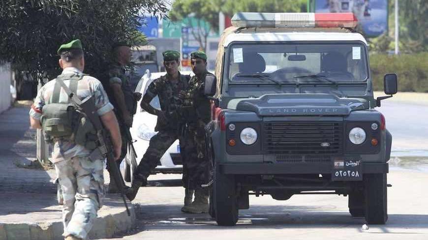 Lebanese Army soldiers patrol the road leading to Beirut international airport, following the kidnap of a Turkish airlines pilot and his colleague in Beirut, August 9, 2013. A Turkish Airlines pilot and his colleague were abducted in Lebanon on Friday by armed men who forced them from a bus driving from Beirut airport in the early hours of the morning. The Turkish foreign ministry and the airline said they were in close contact with the Lebanese authorities but had no immediate information on who was behind