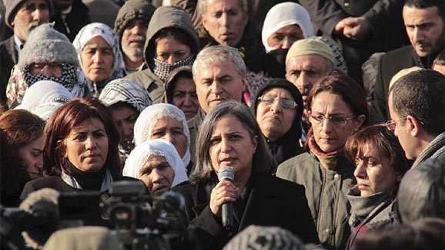 Gultan Kisanak (C), co-leader of Turkey's pro-Kurdish opposition Peace and Democracy Party (BDP), makes a speech on the killing of three female Kurdish activist during a demonstration in Diyarbakir, southeastern Turkey, January 10, 2013. Three female Kurdish activists including a founding member of the PKK rebel group were shot dead in Paris overnight in execution-style killings condemned by Turkish politicians trying to broker a peace deal. REUTERS/Sertac Kayar (TURKEY - Tags: POLITICS CIVIL UNREST) - RTR3