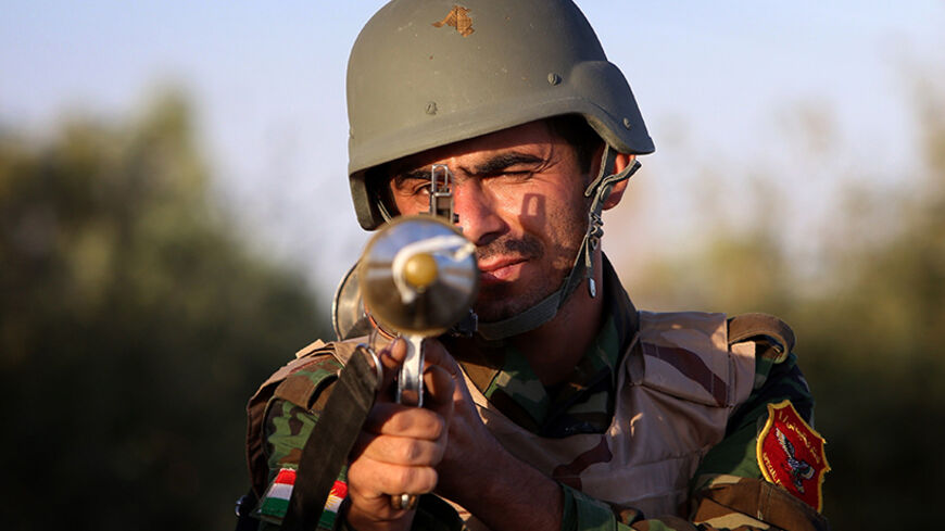 An Iraqi Kurdish Peshmerga fighter poses for a picture on the front line in Makhmur, about 280 kilometres (175 miles) north of the capital Baghdad, during clashes with Islamic State (IS) militants on August 9, 2014. Makhmur, is one of the areas that had been attacked by jihadist fighters in recent days. AFP PHOTO/SAFIN HAMED (Photo credit should read SAFIN HAMED/AFP/Getty Images)