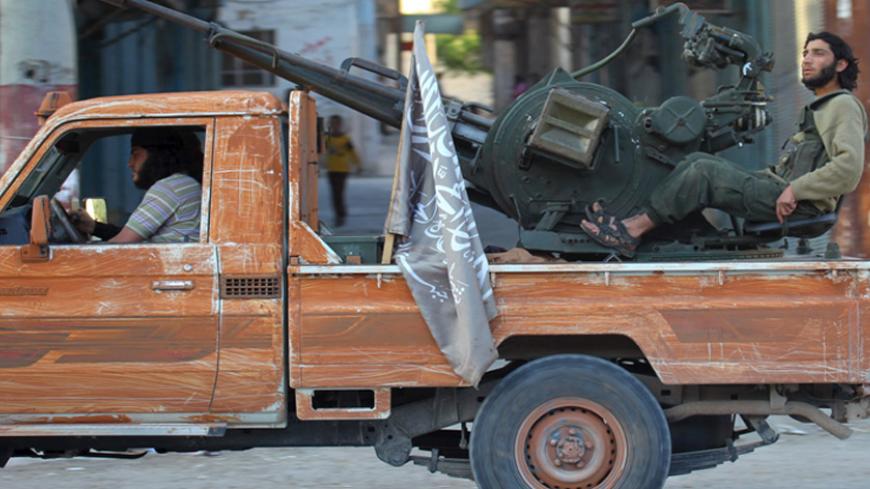 Members of al Qaeda's Nusra Front ride on a pick-up truck mounted with an anti-aircraft weapon in the town of the northwestern city of Ariha, after a coalition of insurgent groups seized the area in Idlib province, May 29, 2015. The Syrian army has pulled back from the northwestern city of Ariha after a coalition of insurgent groups seized the last city in Idlib province in northwestern Syria near the Turkish border that was still held by the government. A coalition of rebel groups called Jaish al Fateh, or