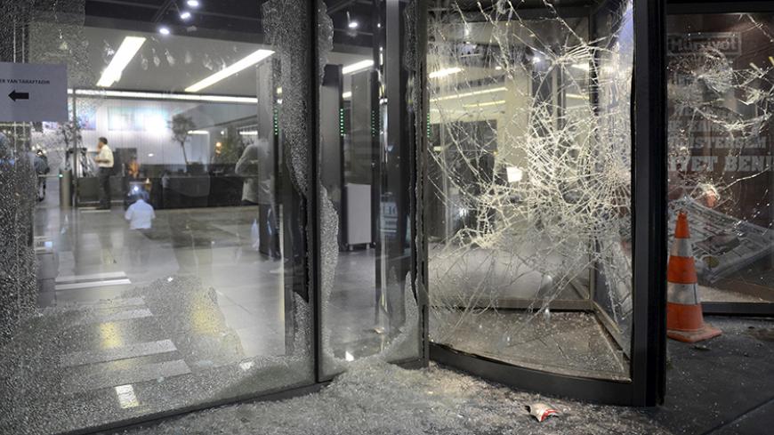Smashed glass is seen at the damaged entrance of the headquarters of the Hurriyet daily newspaper in Istanbul, Turkey, September 8, 2015. Turkish Prime Minister Ahmet Davutoglu appealed for calm on Tuesday after crowds angered by renewed Kurdish militant violence attacked newspapers and offices of a pro-Kurdish political party. The unrest took place after Kurdish militants killed 15 police officers in two bombings in eastern Turkish provinces. The PKK attacks have triggered nationalist anger against Kurds. 