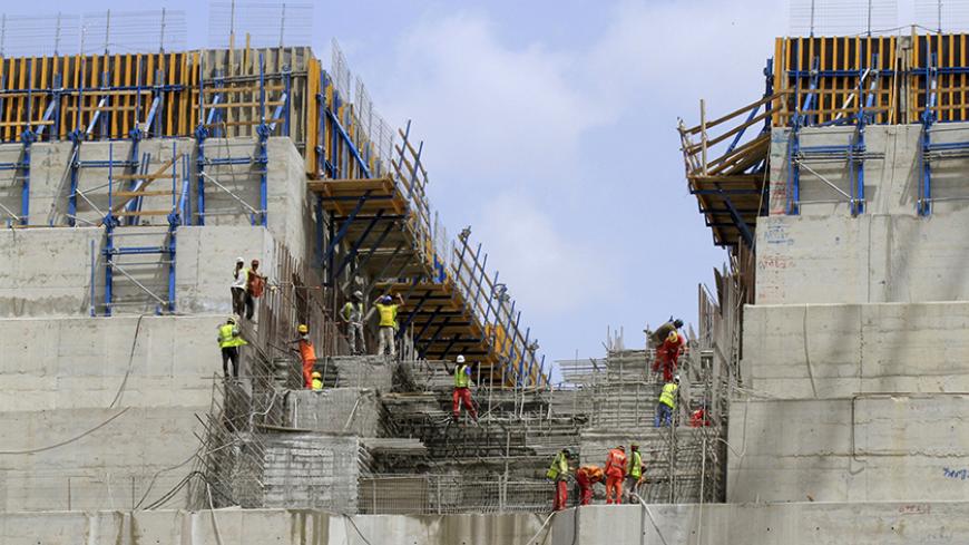 Construction workers are seen in a section of Ethiopia's Grand Renaissance Dam, as it undergoes construction, during a media tour along the river Nile in Benishangul Gumuz Region, Guba Woreda, in Ethiopia March 31, 2015. According to a government official, the dam has hit the 41 percent completion mark. Picture taken March 31, 2015. REUTER/Tiksa Negeri  - RTR4VQ4C