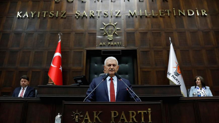 Turkey's Prime Minister Binali Yildirim addresses members of parliament from his ruling AK Party (AKP) during a meeting at the Turkish parliament in Ankara, Turkey, April 18, 2017. REUTERS/Umit Bektas - RC18BE492CA0
