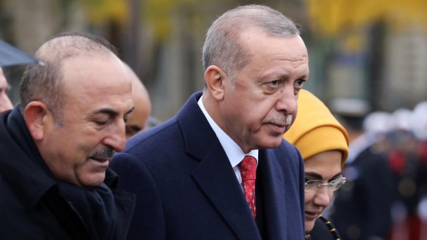 Turkish President Recep Tayyip Erdogan and Turkish Foreign Minister Mevlut Cavusoglu leave a commemoration ceremony for Armistice Day, 100 years after the end of the First World War, at the Arc de Triomphe, in Paris, France, November 11, 2018. Ludovic Marin/Pool via REUTERS - RC14BD6A5800