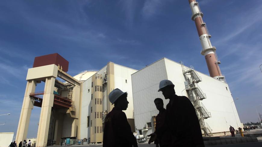 Iranian workers stand in front of the Bushehr nuclear power plant, about 1,200 km (746 miles) south of Tehran October 26, 2010. Iran has begun loading fuel into the core of its first nuclear power plant on Tuesday, one of the last steps to realising its stated goal of becoming a peaceful nuclear power, state-run Press TV reported on Tuesday. REUTERS/Mehr News Agency/Majid Asgaripour (IRAN - Tags: POLITICS ENERGY IMAGES OF THE DAY) - GM1E6AQ1G1401