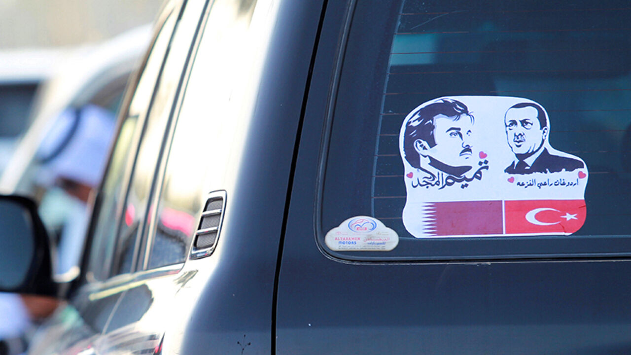 GULF-QATAR/ The pictures of Qatarís Emir Sheikh Tamim Bin Hamad Al-Thani (L) and Turkish President Tayyip Erdogan are seen on a car during a demonstration in support of him in Doha, Qatar June 11, 2017. REUTERS/Naseem Zeitoon - RTS16KYO